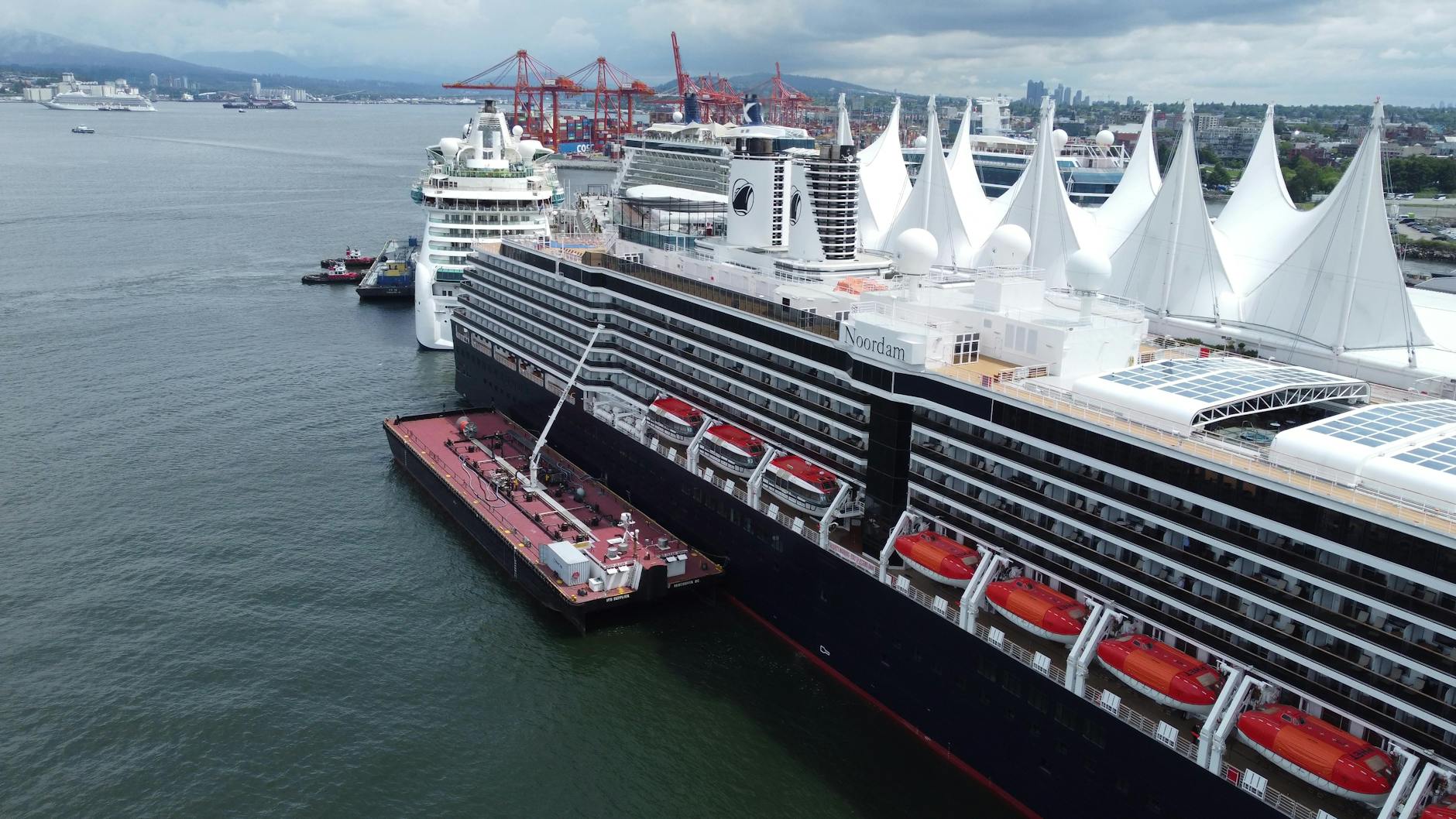 Large cruise ship docked at an urban port terminal at sunset
