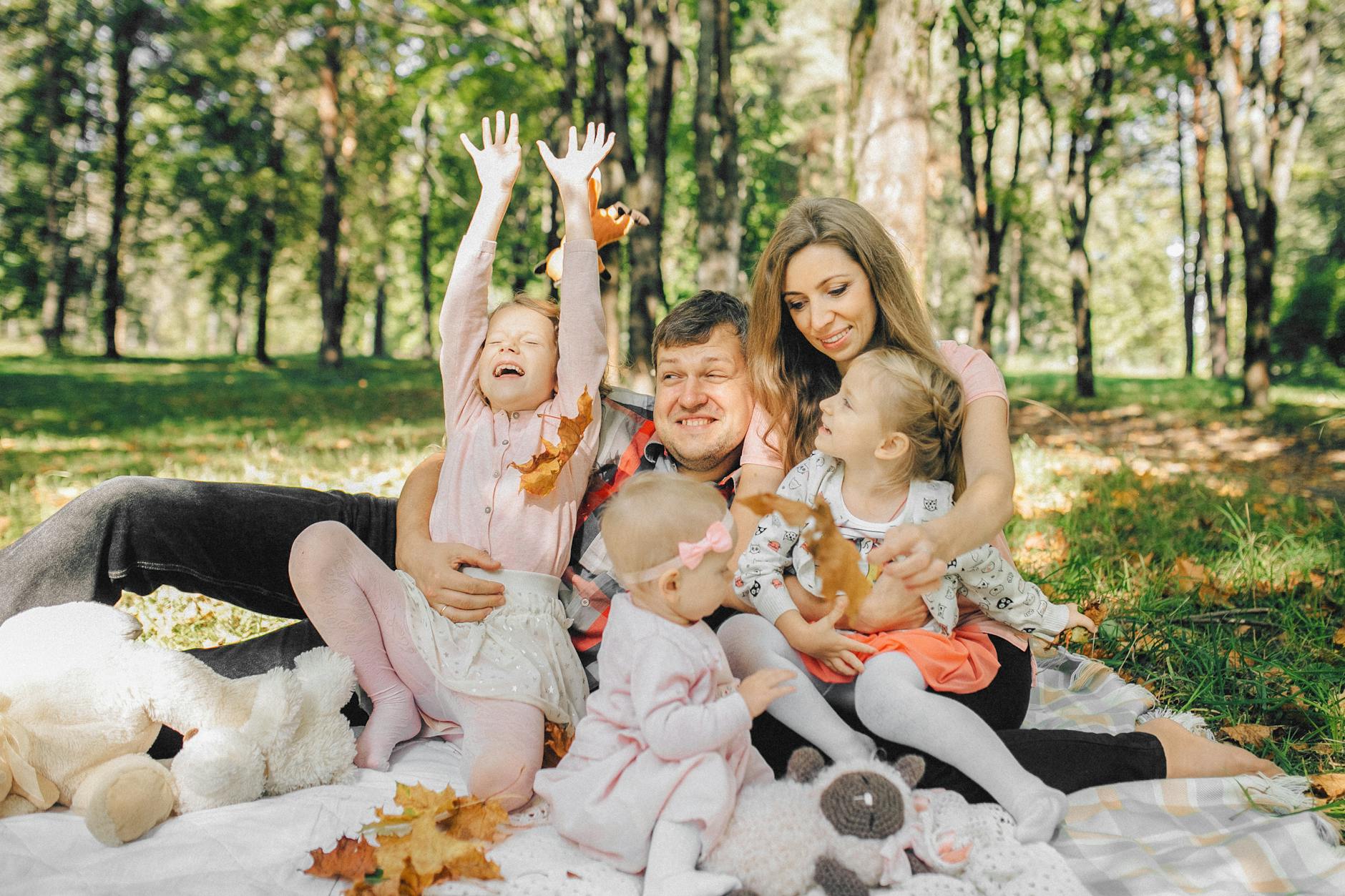 Family with children walking in a forest park