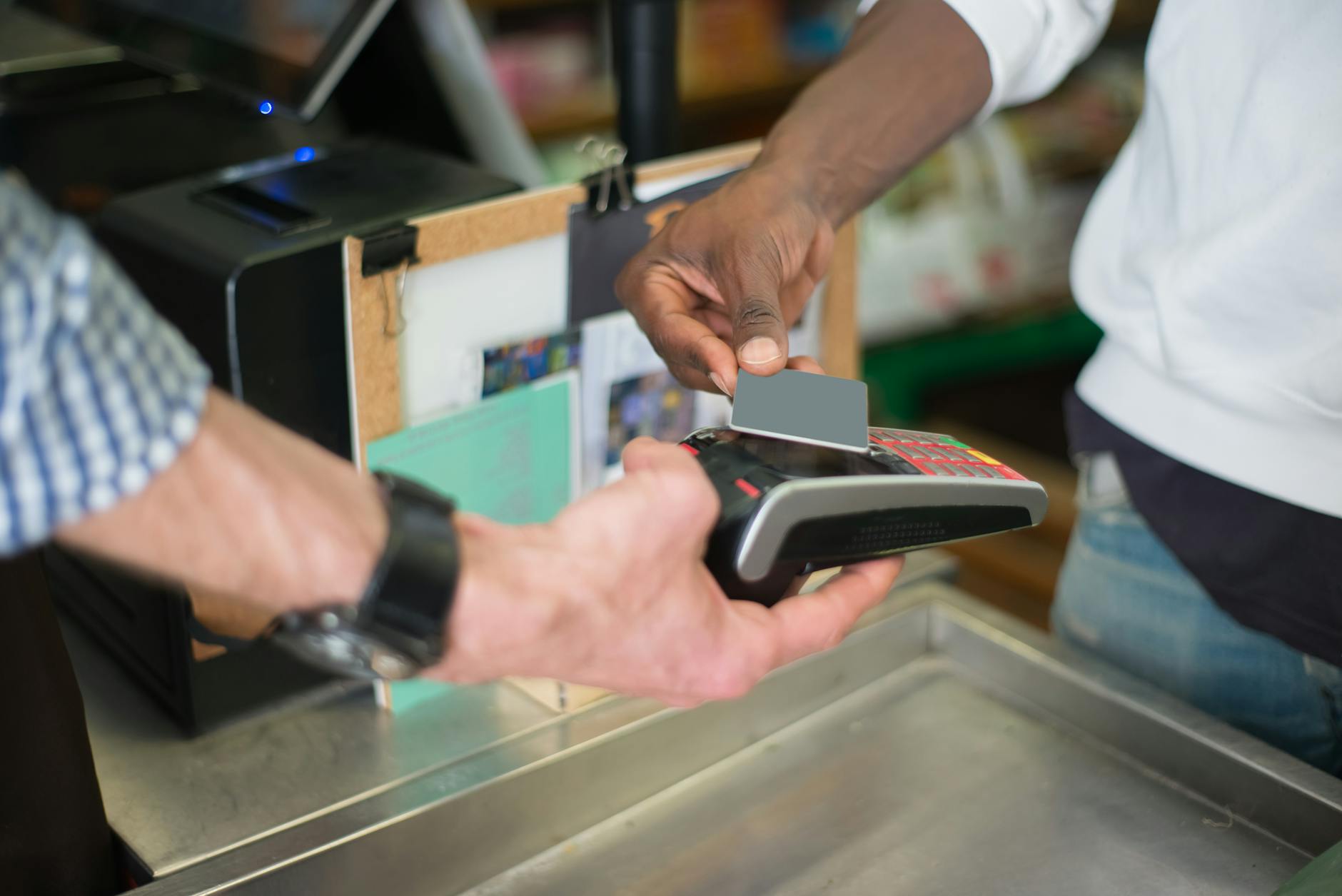Passenger tapping a transit card on a fare gate reader