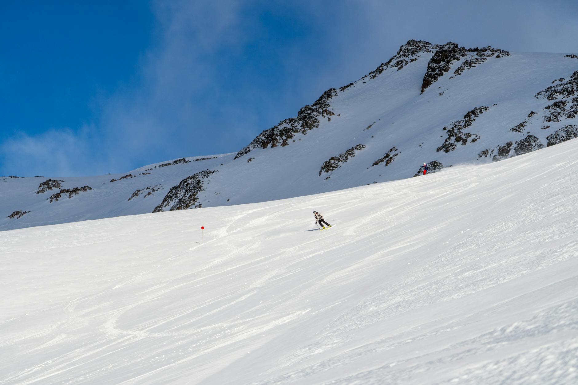 Skier on mountain run with fresh snow