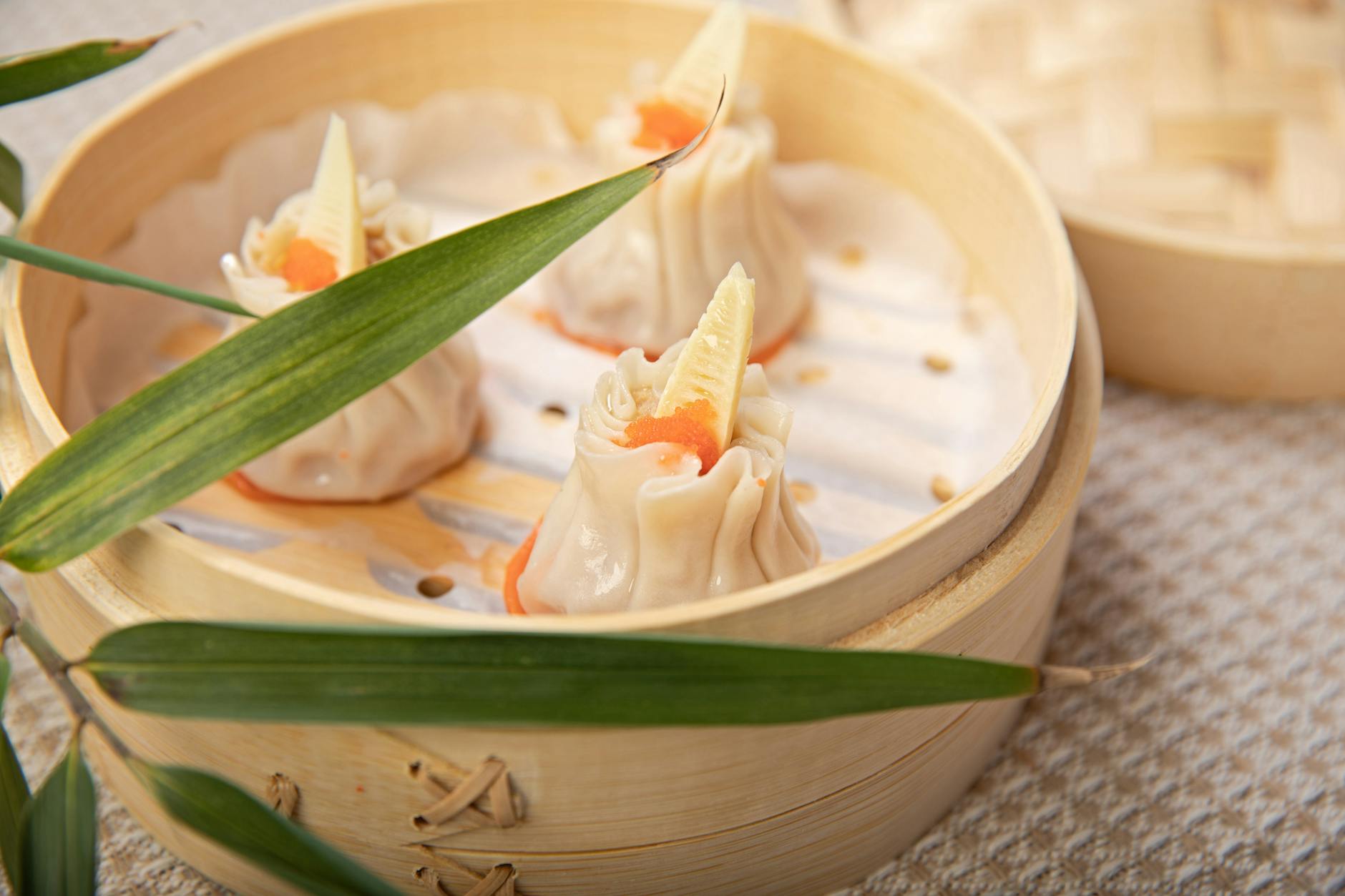 Dim sum dumplings in bamboo steamer baskets