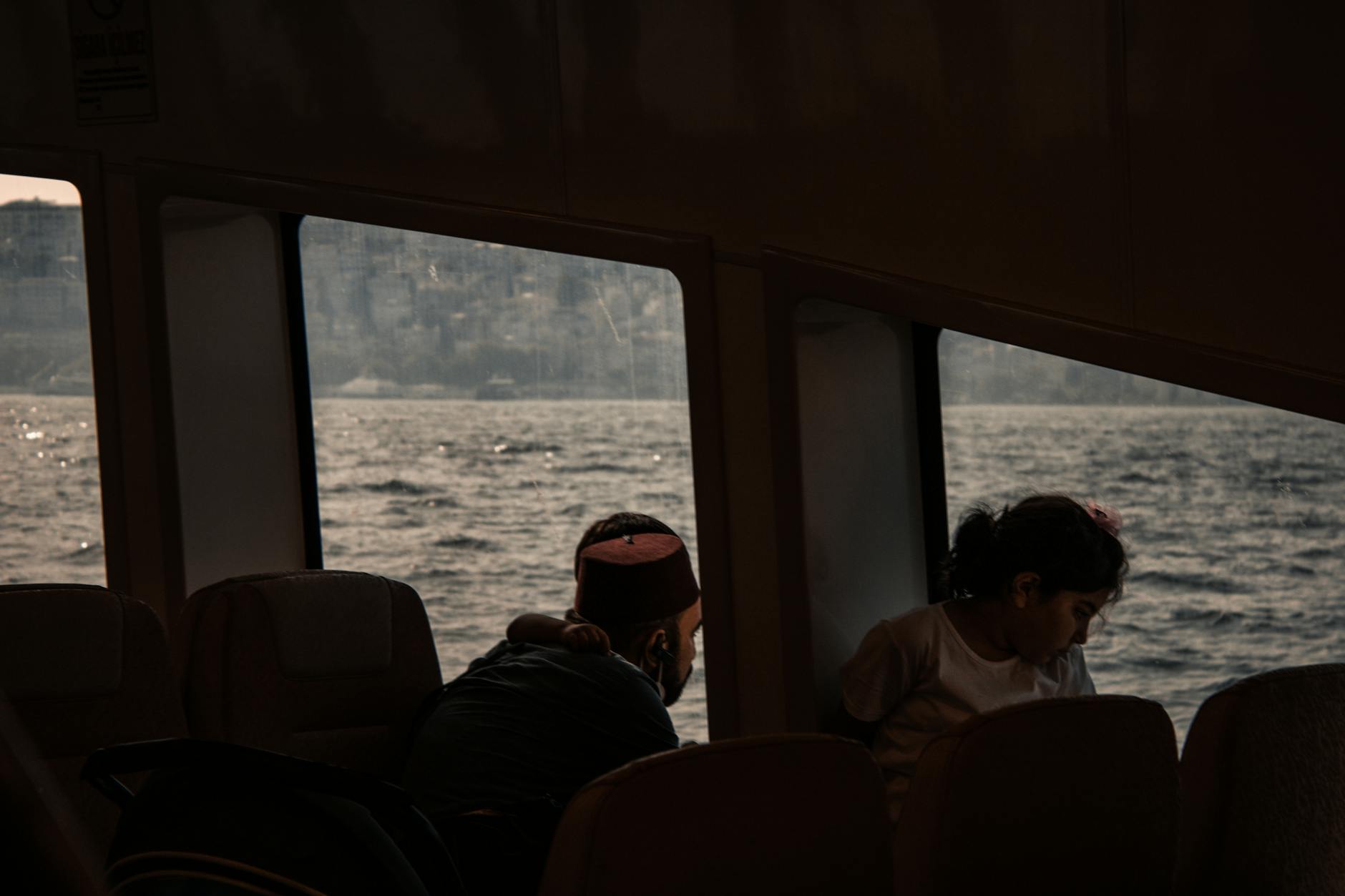 Ferry passengers family on deck with water
