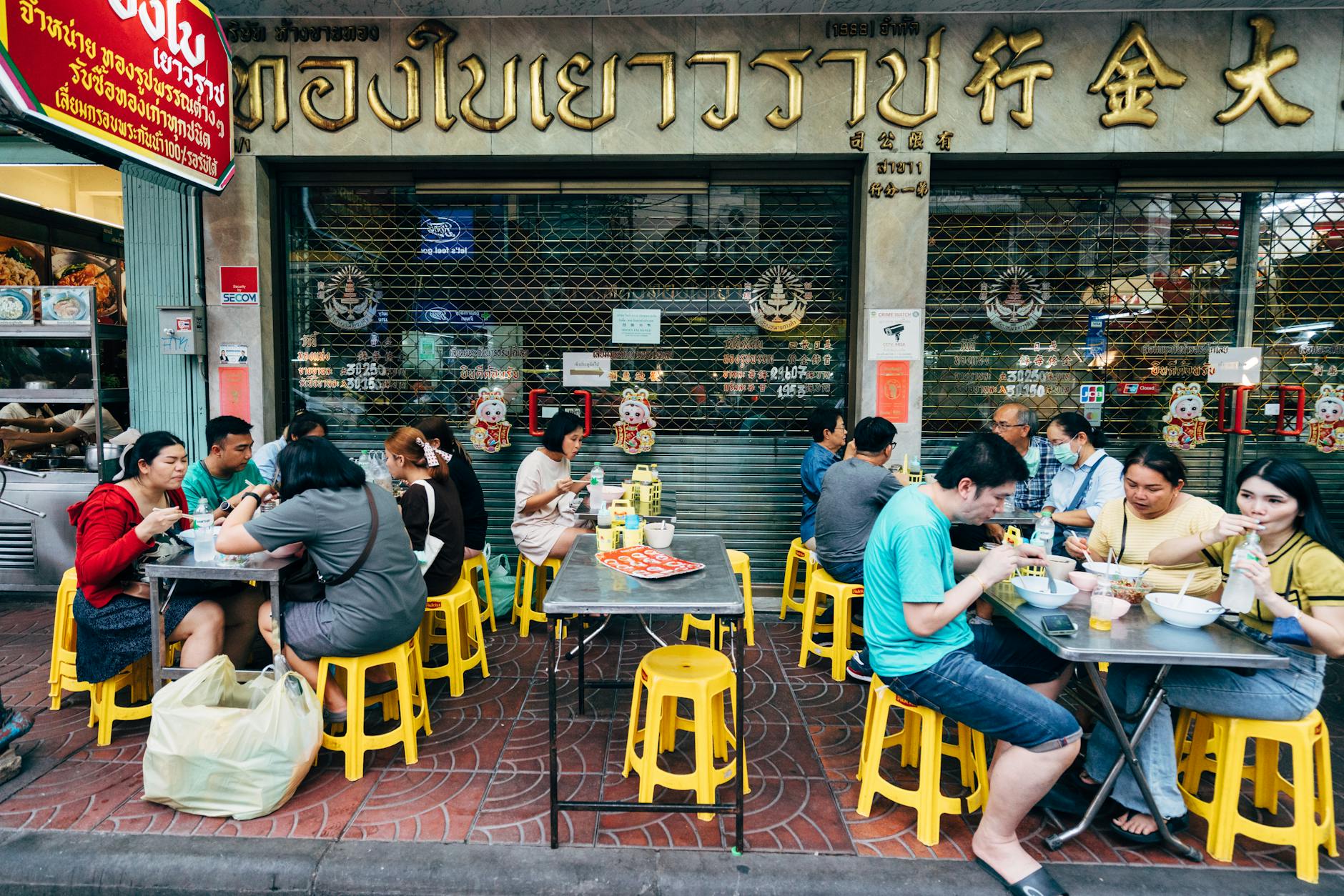 Food tour group on city street sampling dishes