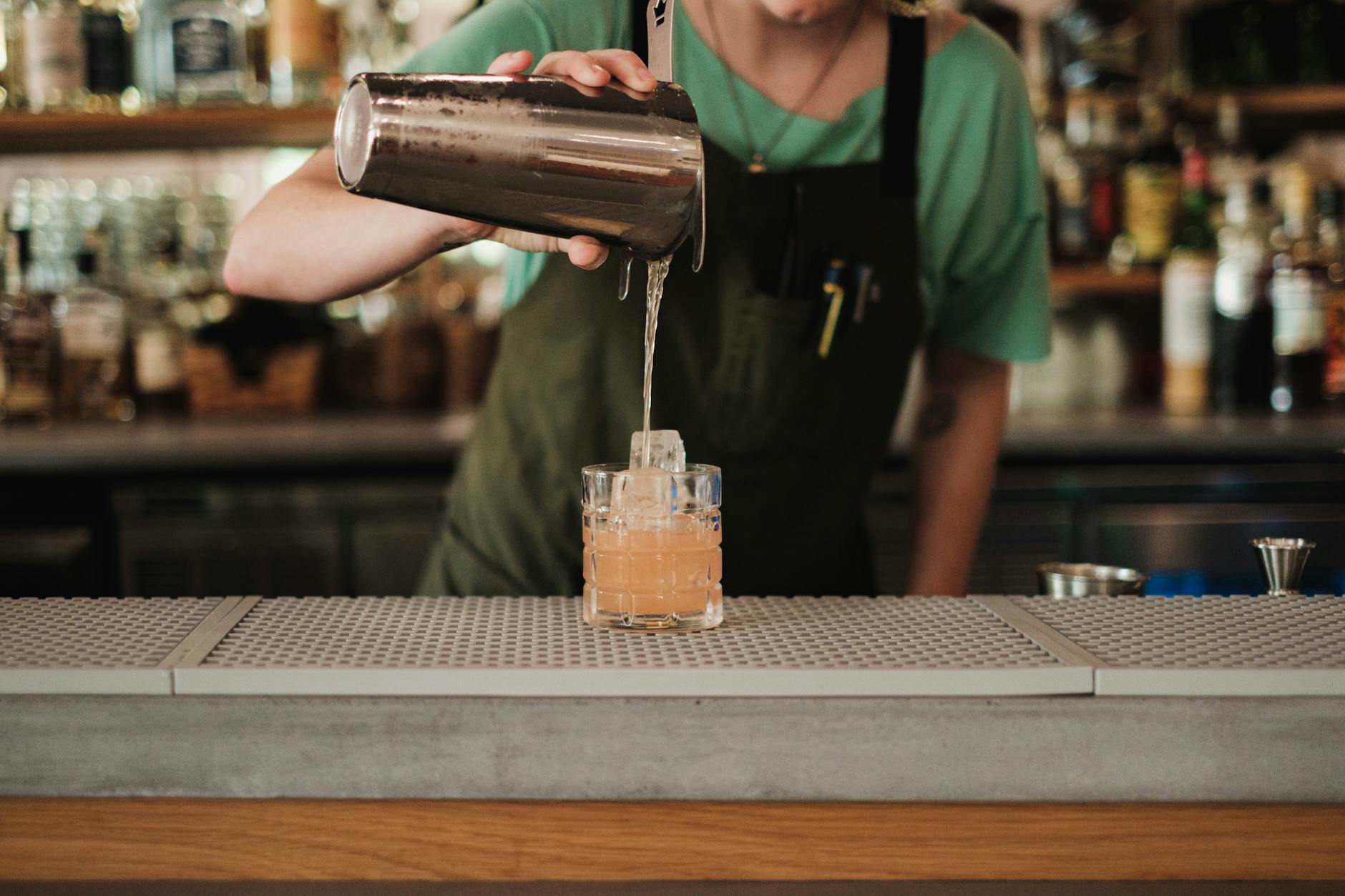 Bartender pouring a craft cocktail