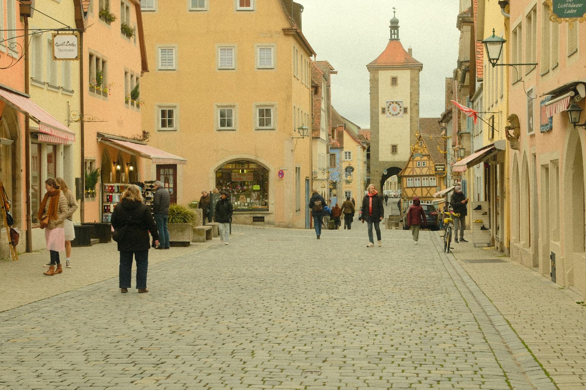 Tourists walking on a historic cobblestone street