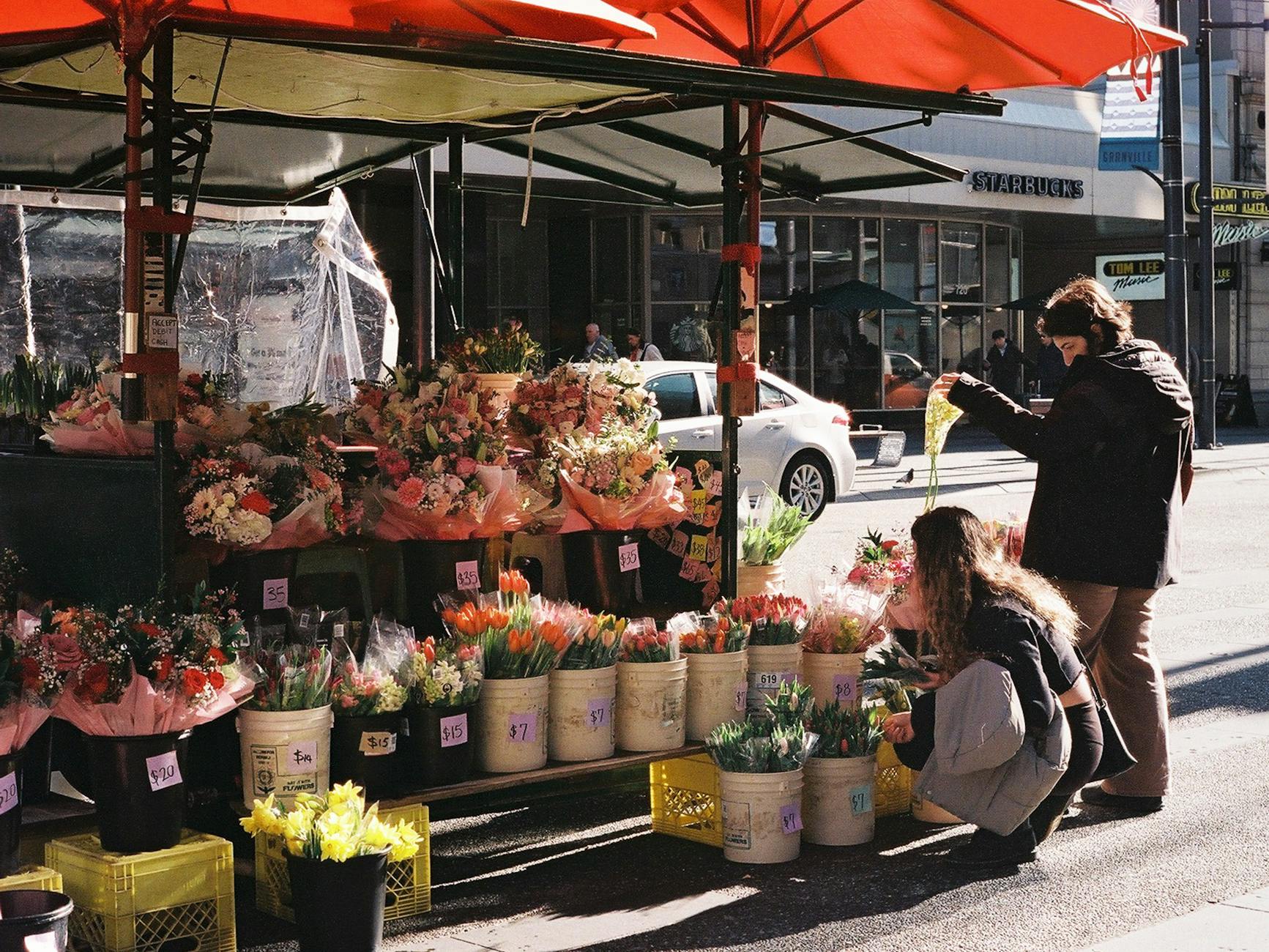 Fresh produce stall inside Granville Island Public Market with colorful fruits and vegetables