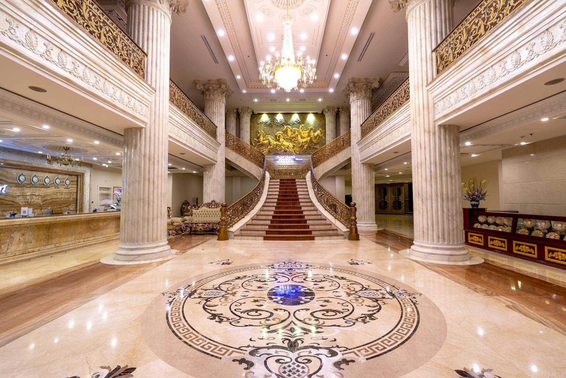 Elegant hotel lobby with marble floor, chandelier and curated art