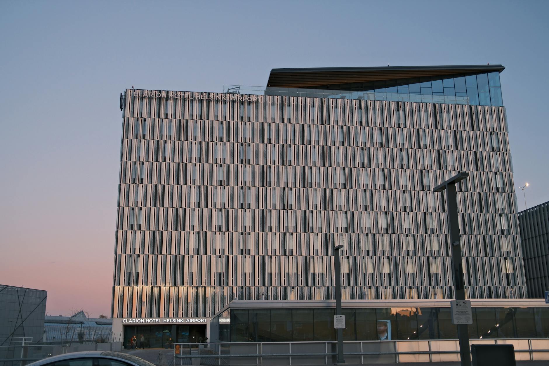 Modern airport hotel exterior with glass lobby entrance