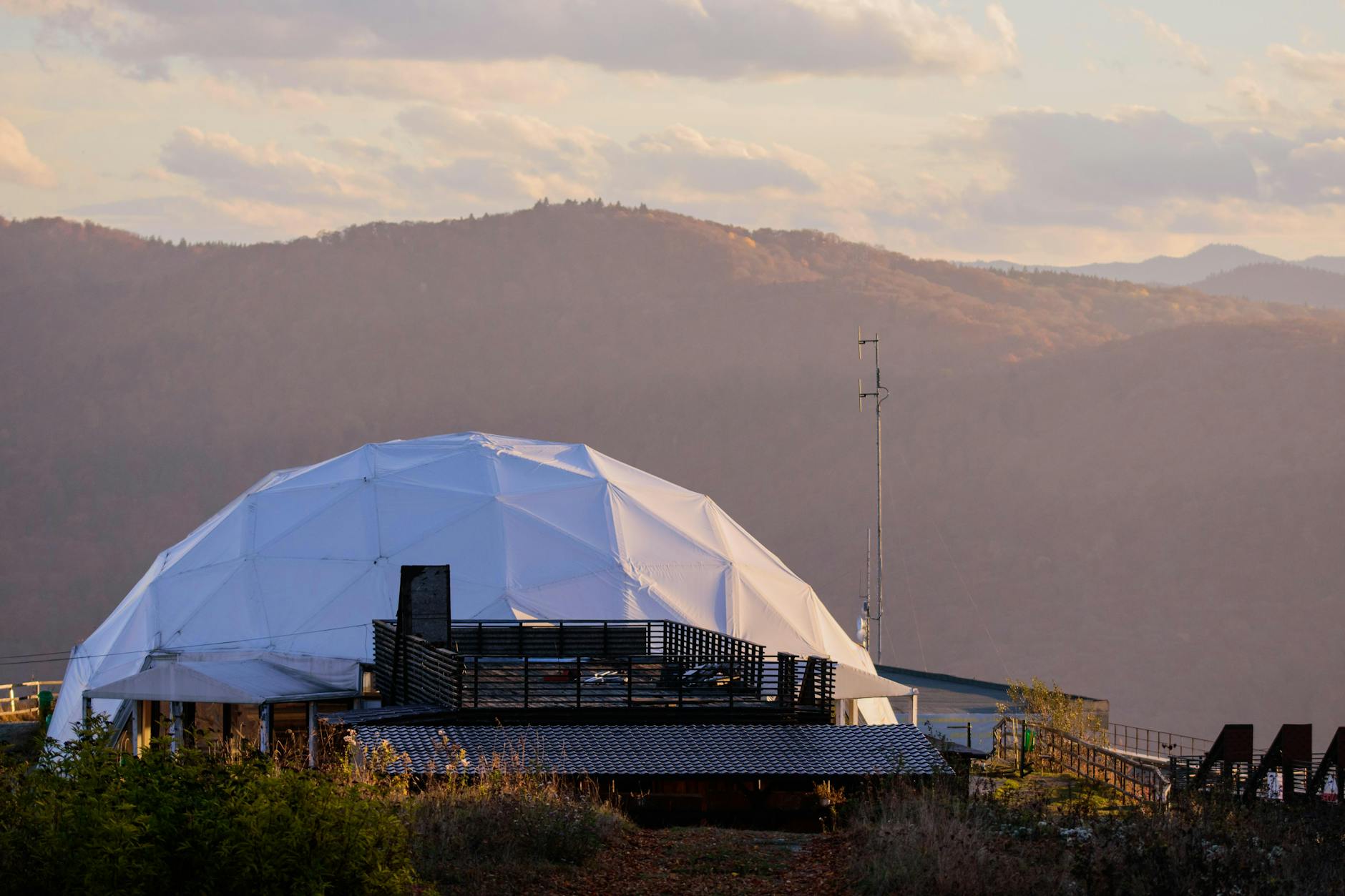 Geodesic dome science centre at dusk with reflection on calm water