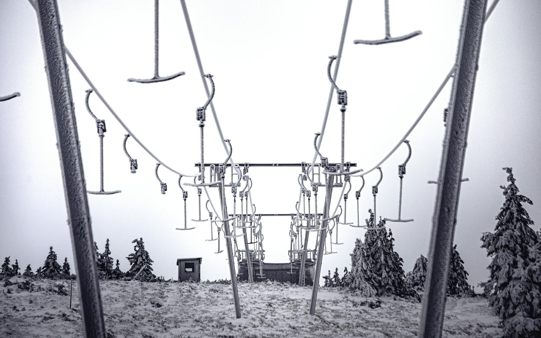 Ski hill and lift on snow-covered mountain