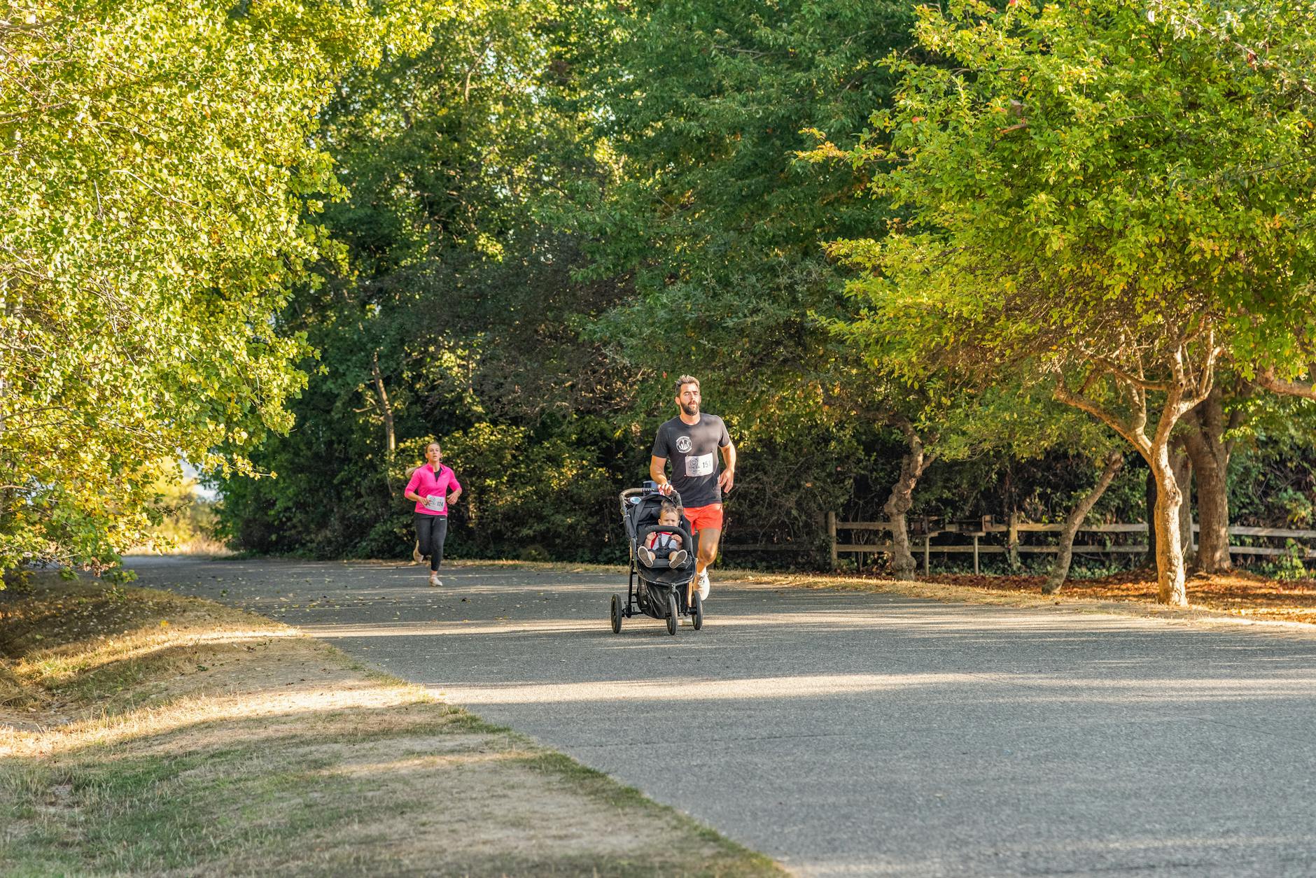 Family with stroller on seawall waterfront path