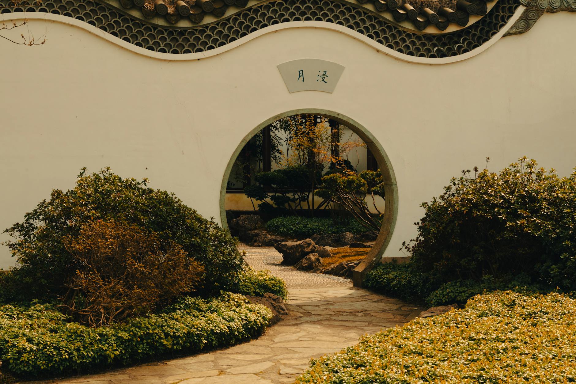 Chinese garden moon gate and stone path