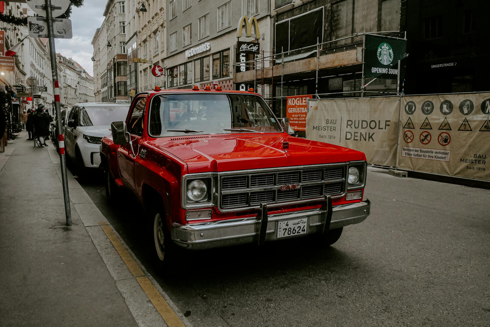 Rideshare vehicle picking up a passenger on a downtown city street