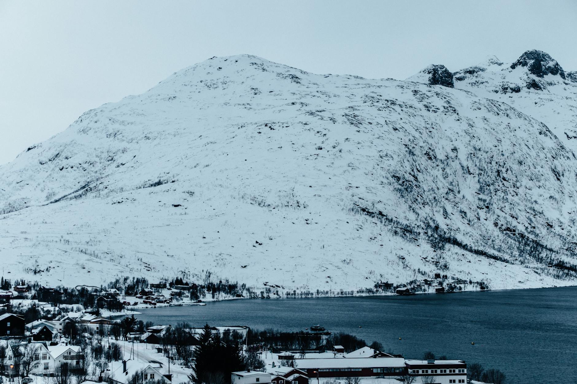 Snow-covered mountain with ski lift cables crossing the frame