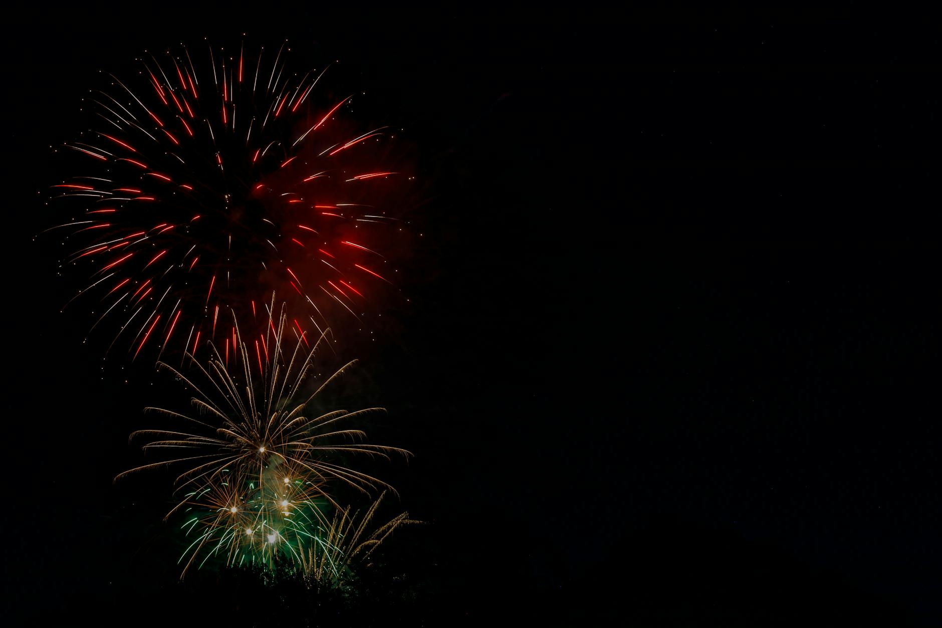 Colorful fireworks burst against a dark sky, capturing the essence of celebration and festivity.