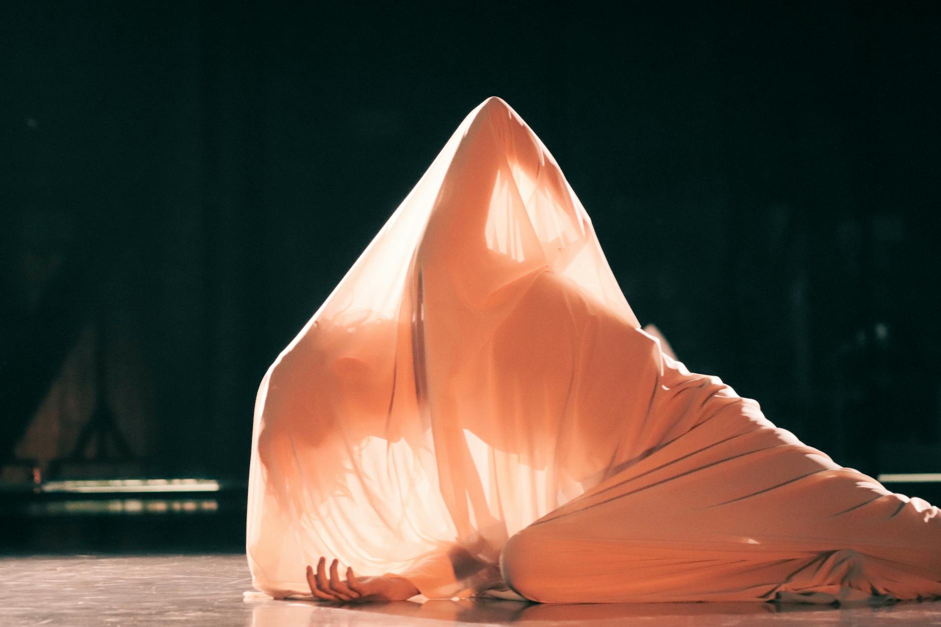 Captivating dance performance with fabric creating ethereal movement on stage in Bogotá.