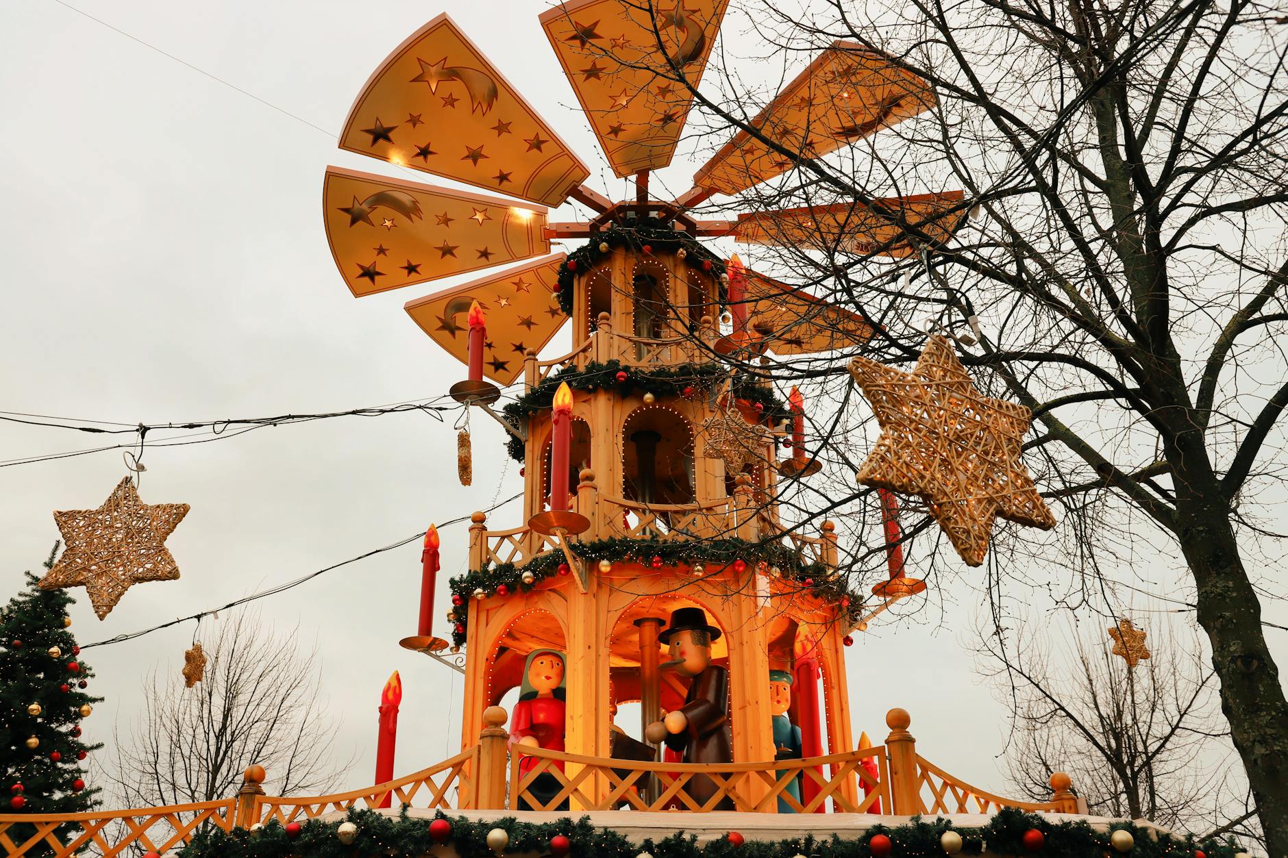 Wooden Christmas pyramid with festive decorations at a market in Kassel, Germany.