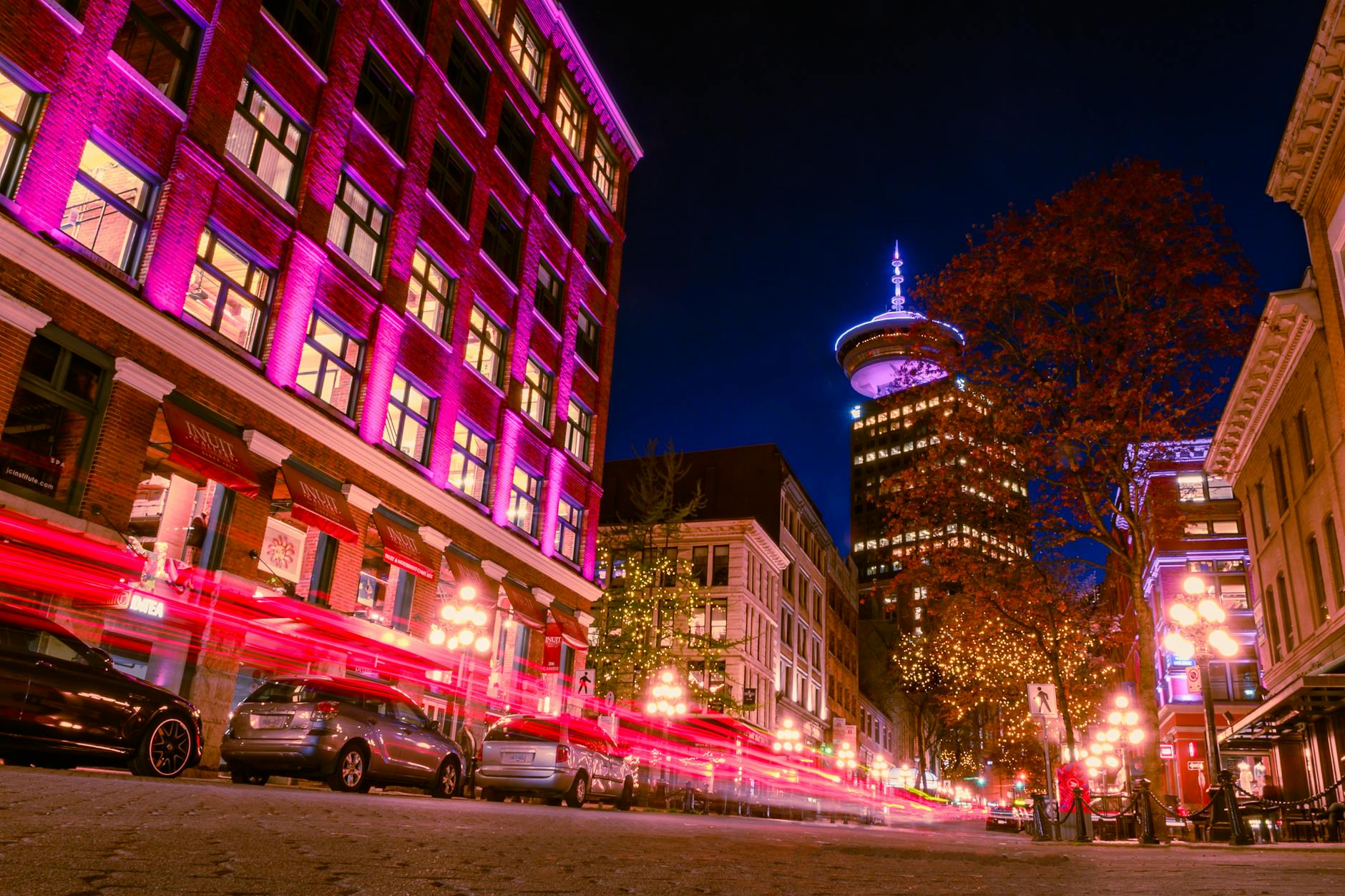 Captivating long exposure of vibrant Vancouver streetlights and architecture during the night.