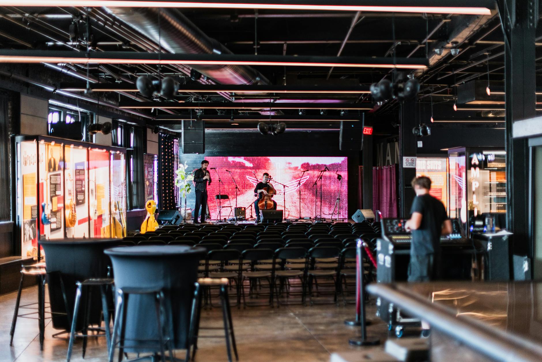 A crowd watching a band in a small standing-room music venue.