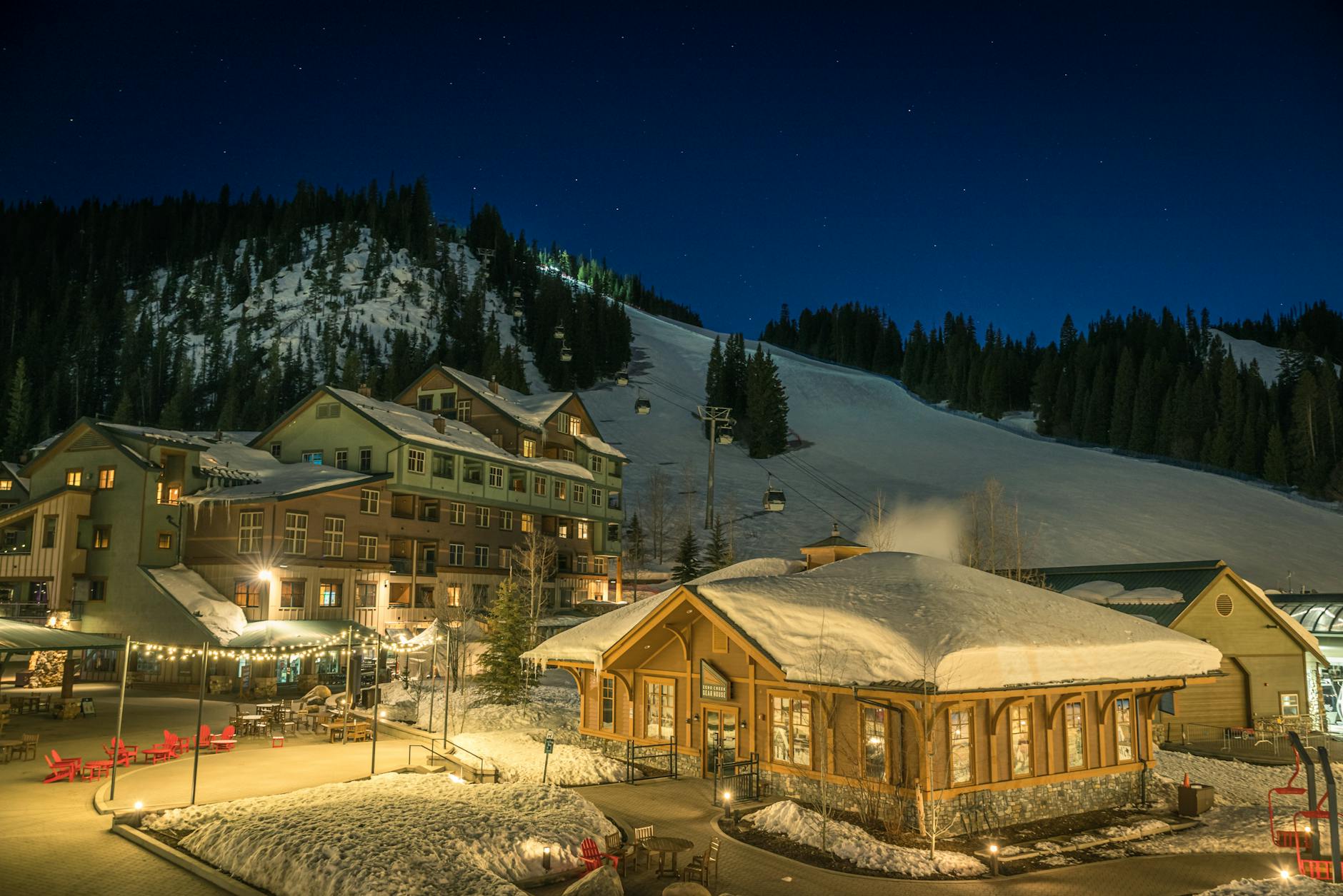 The pedestrian village at Whistler with lights and snow at dusk.