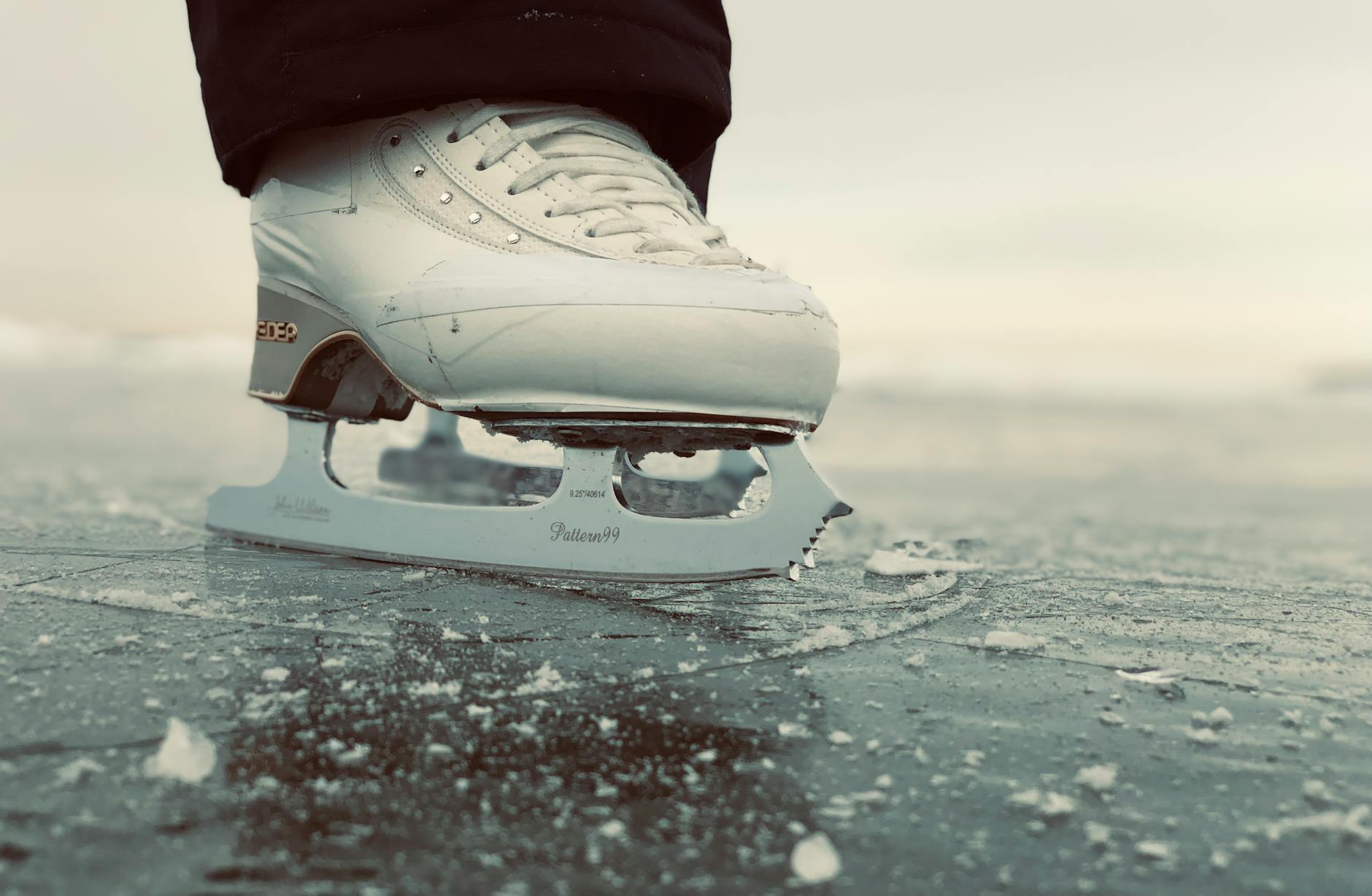 An outdoor rink beside a waterfront with a city skyline behind.