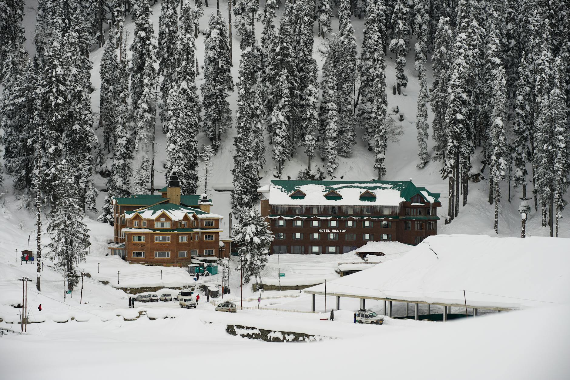 A hotel room with a view over a snowy mountain range.