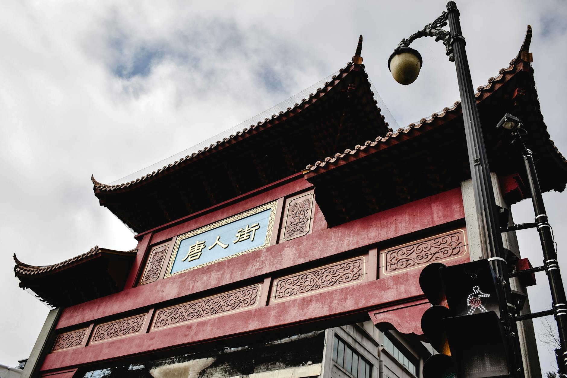 Historic Chinatown storefronts with recessed balconies and painted signage along Pender Street.