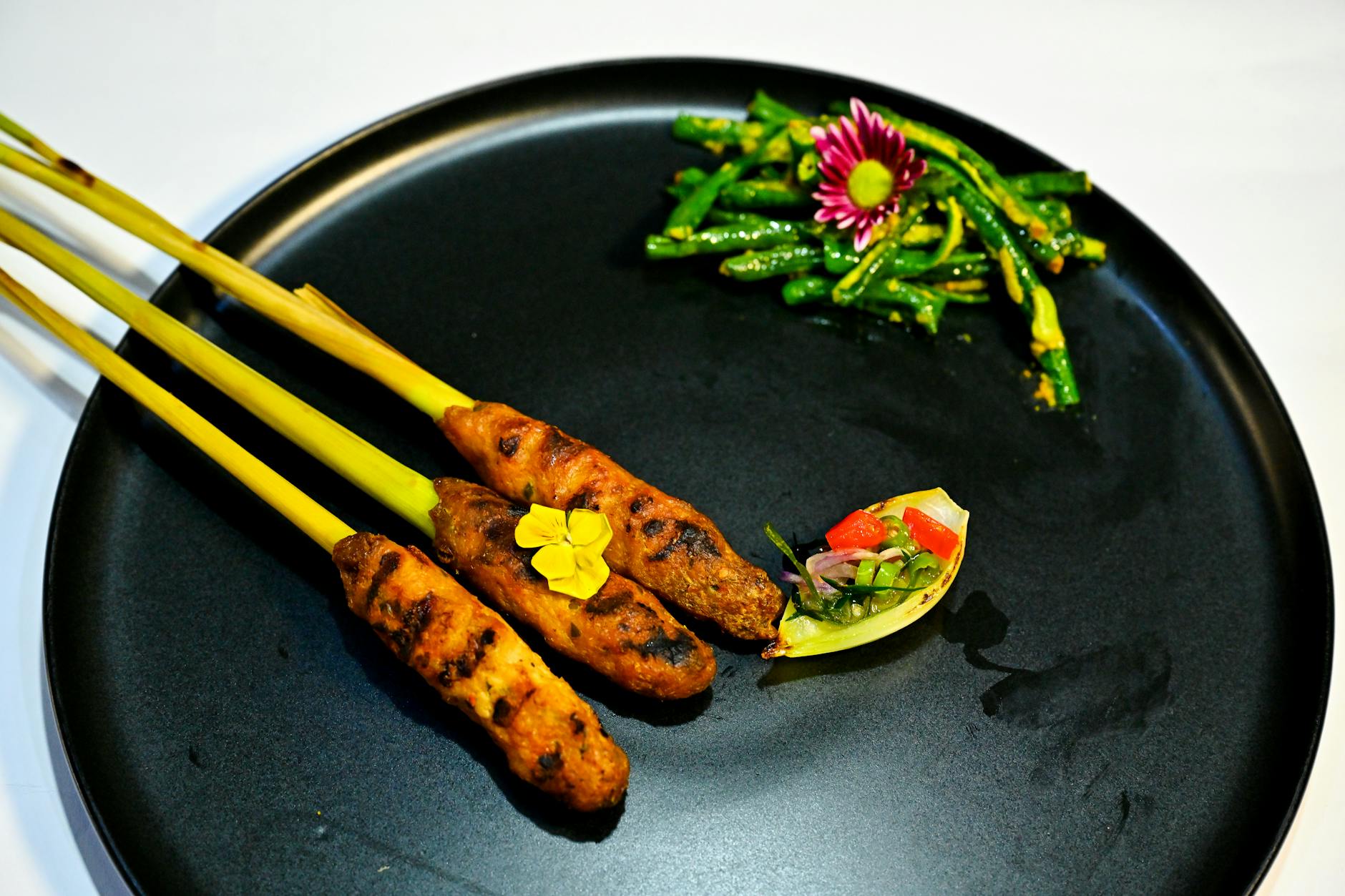 A bison and berry dish plated with foraged garnishes.