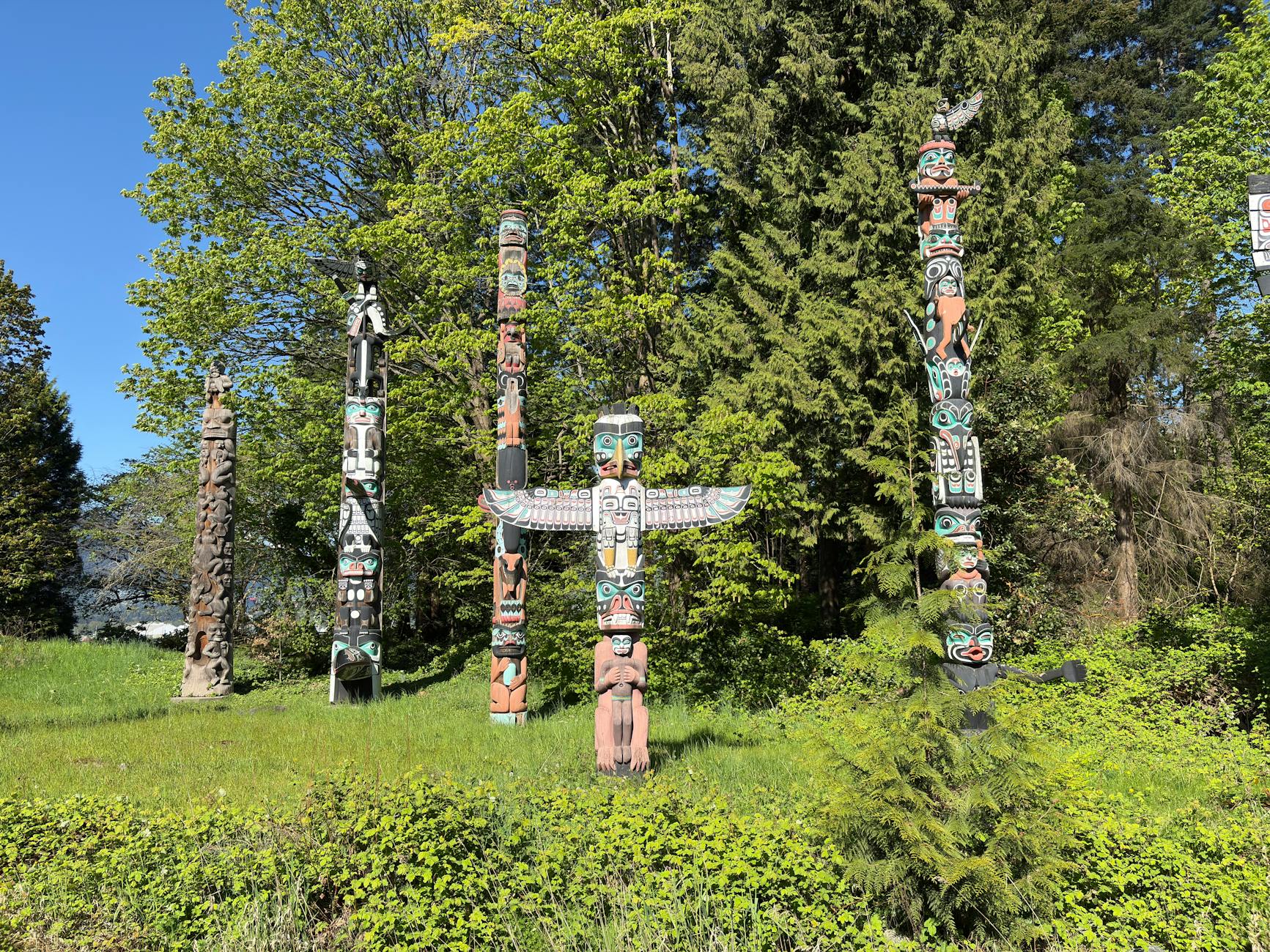 A row of brightly painted totem poles at Brockton Point in Stanley Park.