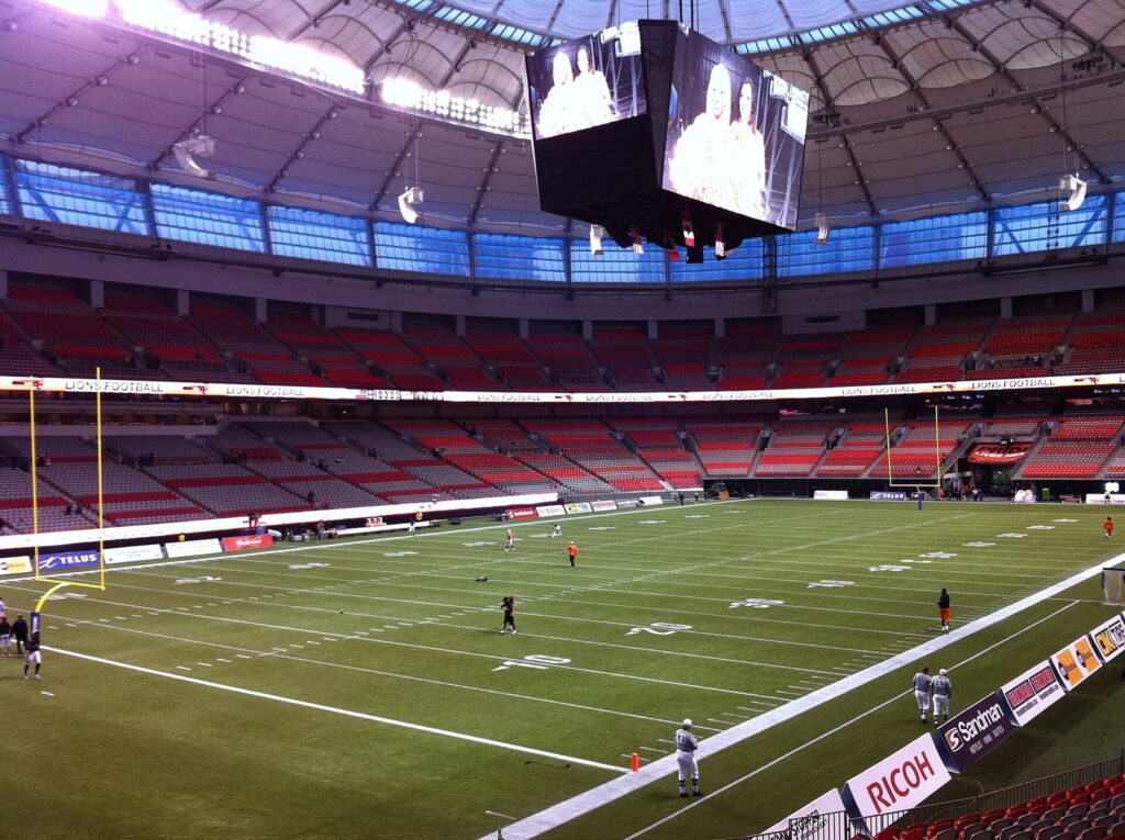 BC Place's lower and upper bowls around a football field under the centre-hung video board