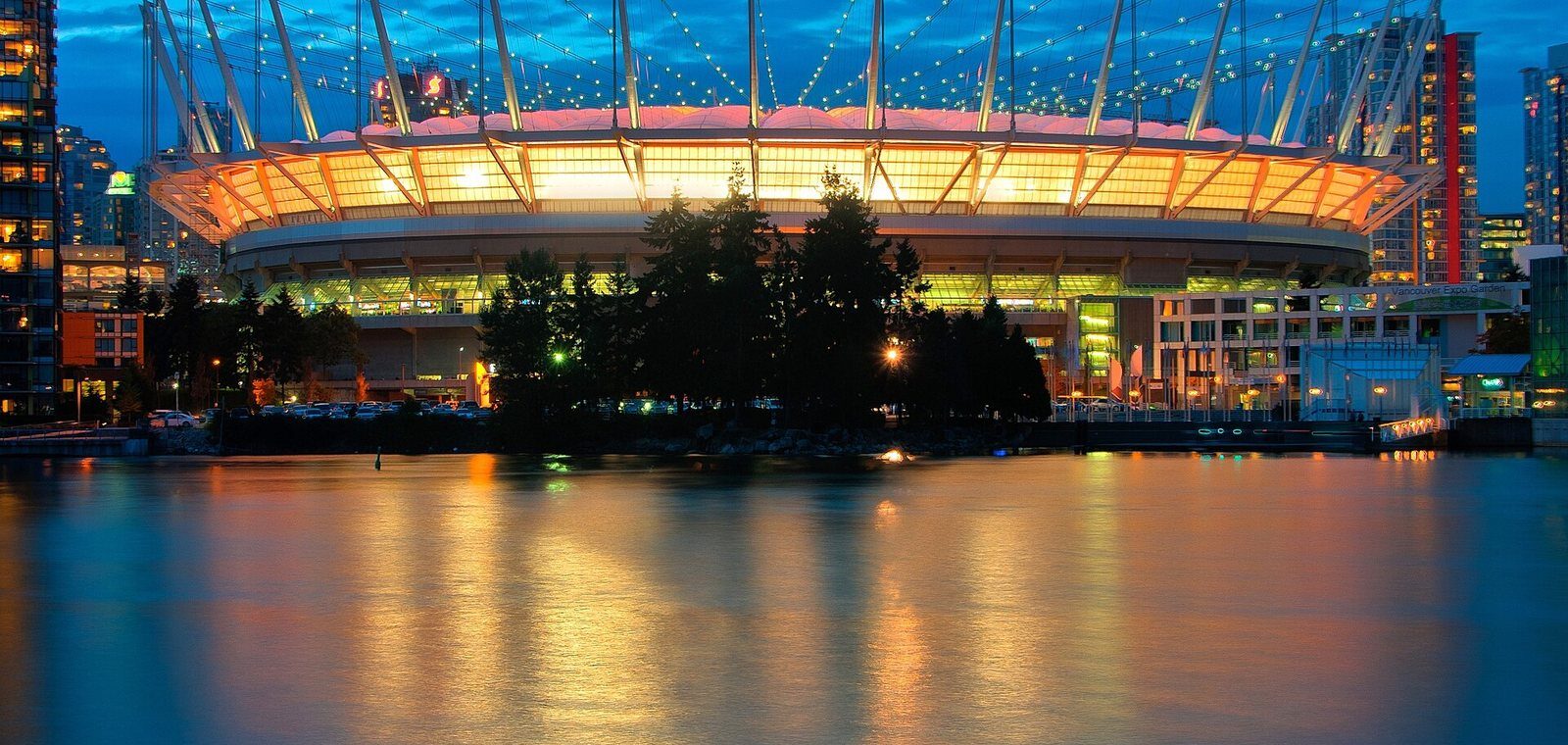 BC Place stadium's lit roof reflected in False Creek at dusk on its 2011 reopening night
