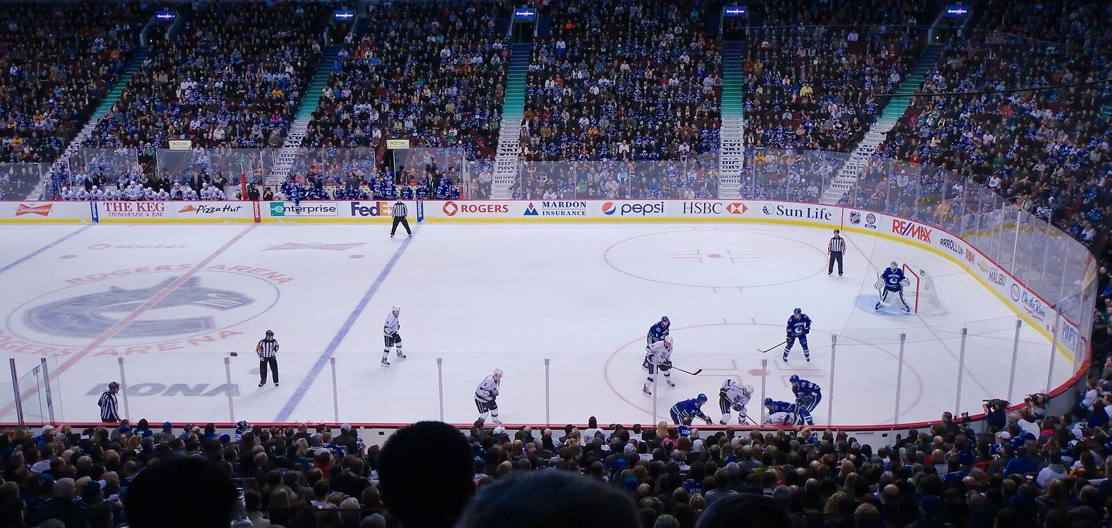 Canucks and Los Angeles Kings at centre ice under the lights of a packed Rogers Arena