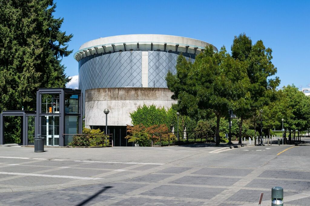 The round, metal-clad Chan Centre for the Performing Arts among trees on the UBC campus
