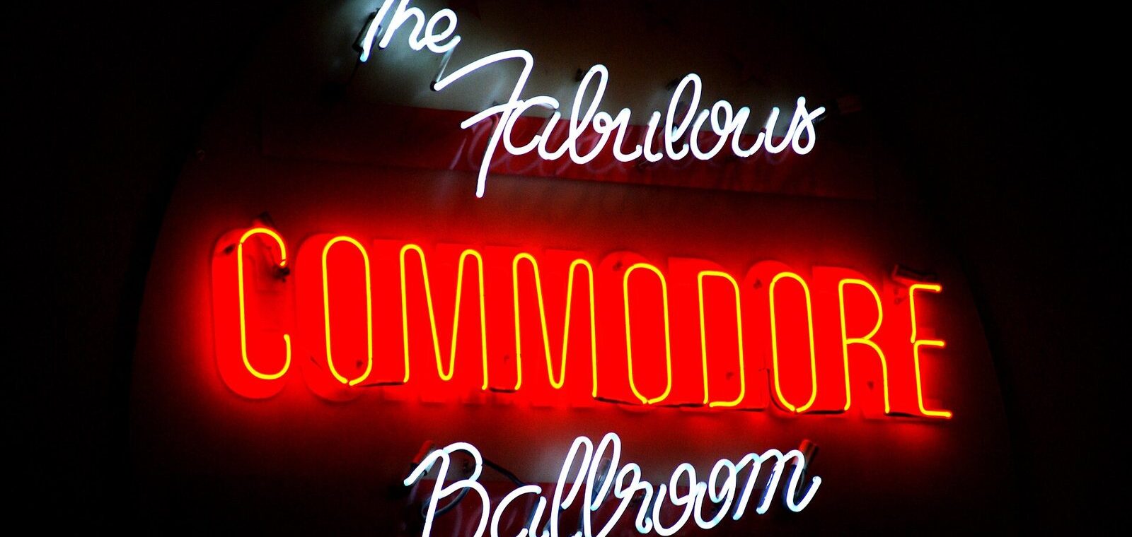 Red and white neon sign reading The Fabulous Commodore Ballroom glowing at night