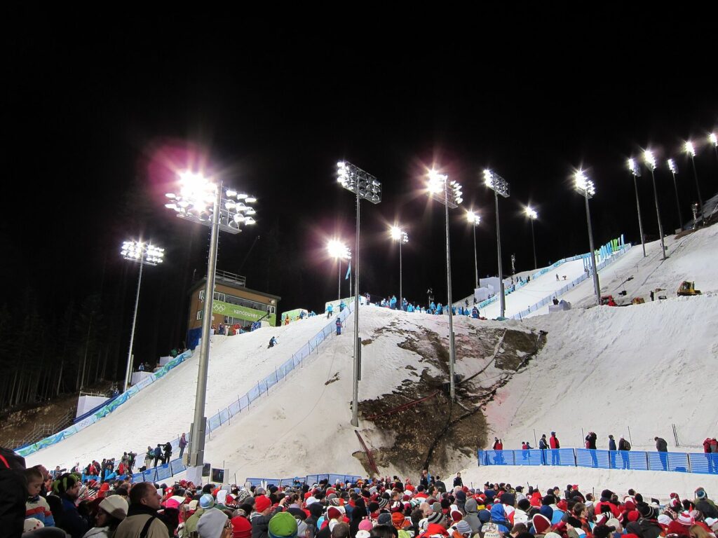 Floodlit freestyle aerials course at Cypress Mountain with crowds of spectators at night