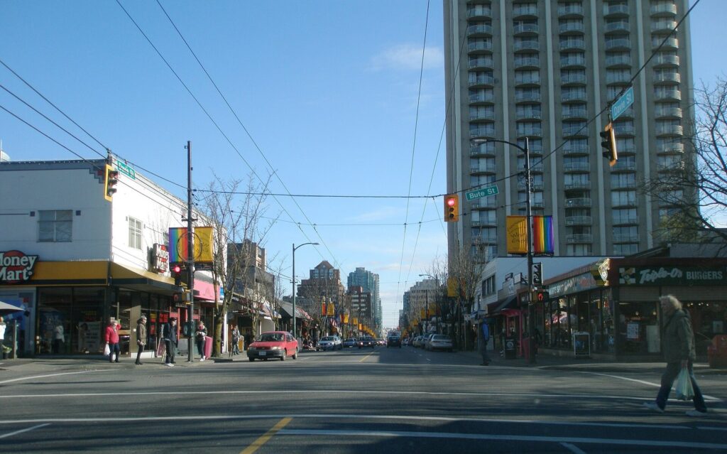 Davie Street in the West End with rainbow banners on the lamp posts and apartment towers behind