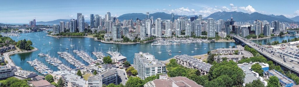 Aerial view of False Creek marinas, downtown towers and the North Shore mountains
