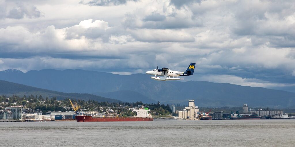 Floatplane lifting off Vancouver Harbour on one of the most booked Vancouver tours, with North Vancouver behind
