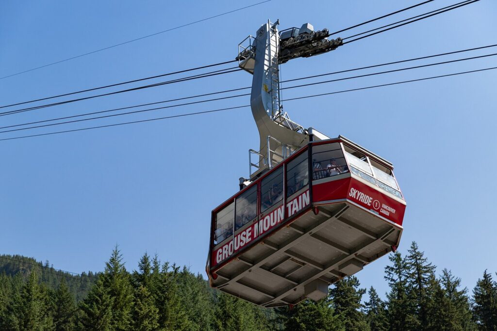Red Grouse Mountain Skyride cabin climbing above the forest on a sunny day