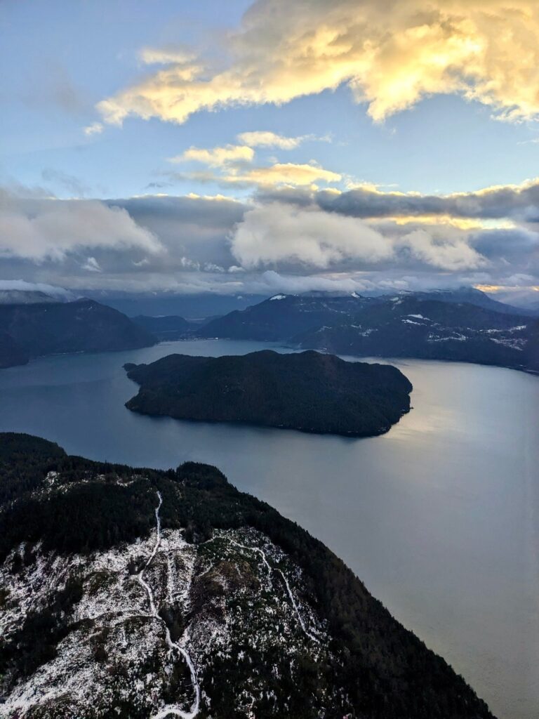 Harrison Lake and Echo Island under evening clouds with mountains around the water