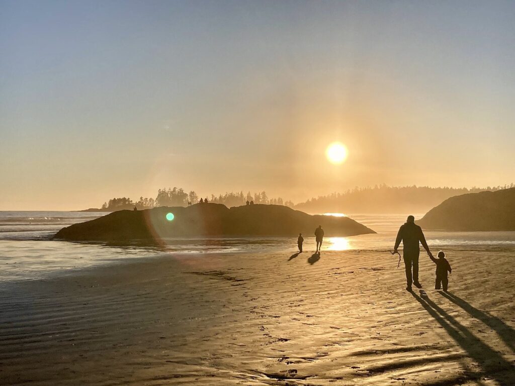 Walkers silhouetted on Long Beach at sunset in Pacific Rim National Park Reserve