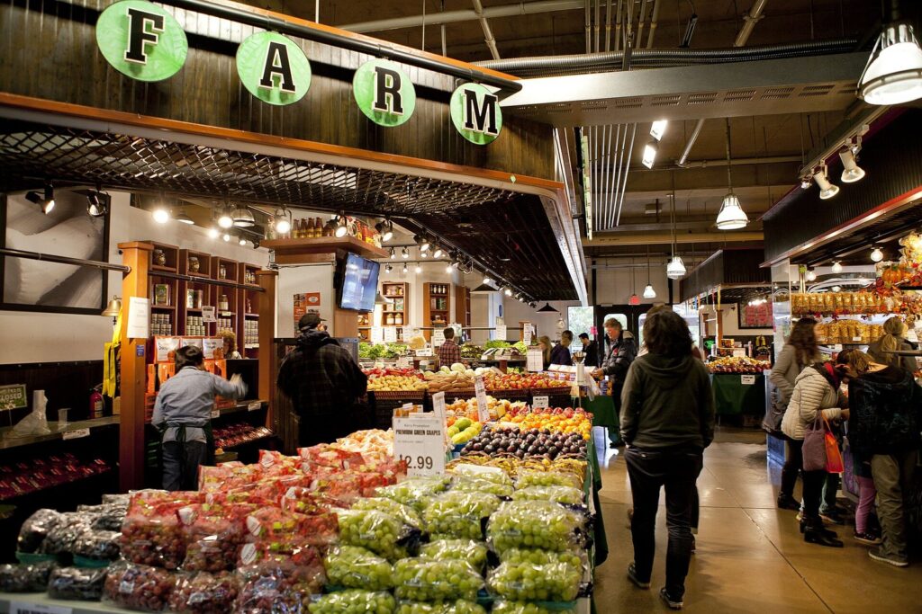 Produce stands and shoppers inside the Lonsdale Quay Market hall in North Vancouver