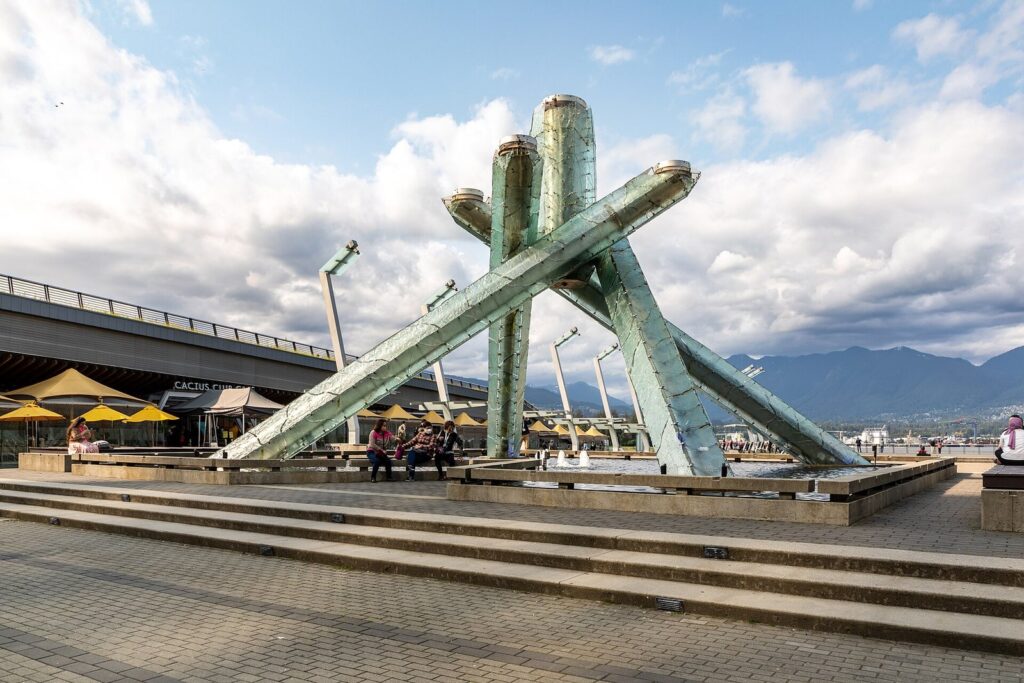 Olympic Cauldron sculpture at Jack Poole Plaza with the North Shore mountains beyond