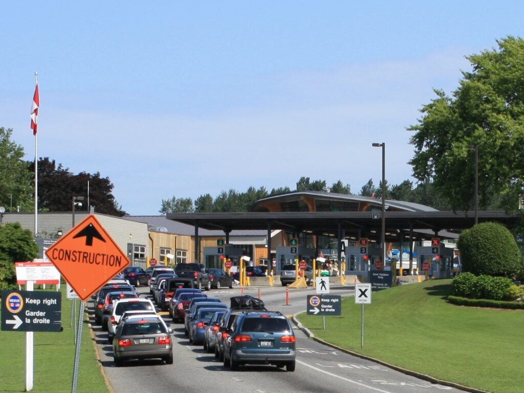 A line of cars waiting to enter Canada at the Peace Arch crossing from Blaine, Washington