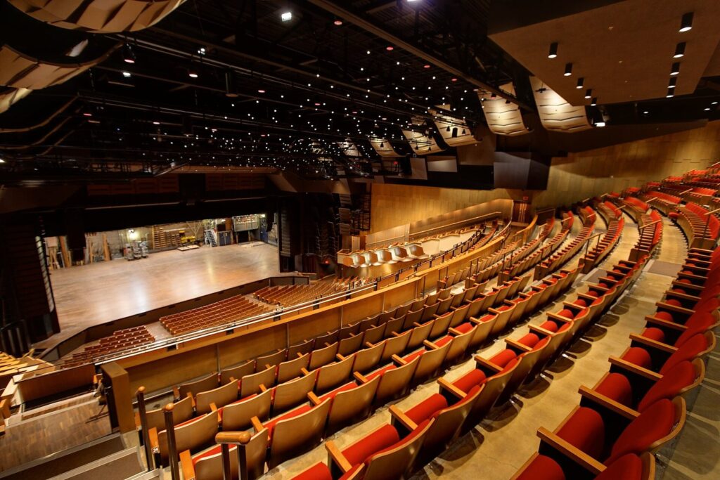 Rows of red seats sweeping toward the stage inside the Queen Elizabeth Theatre, a venue for concerts in Vancouver