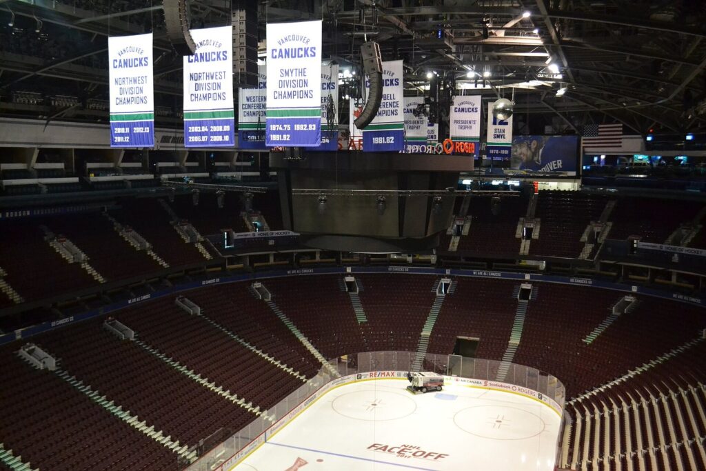 Canucks division banners and retired numbers hanging above the Rogers Arena ice