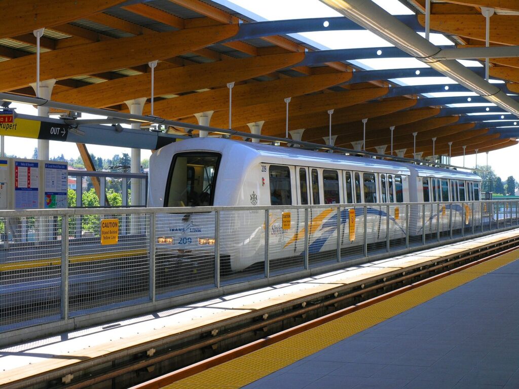 Automated SkyTrain train stopped at the covered platform of Rupert station