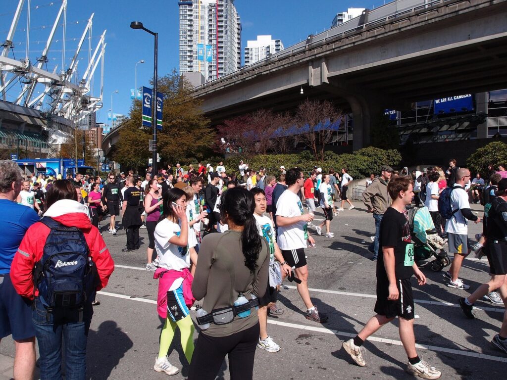 Crowds of runners and walkers in the Vancouver Sun Run passing BC Place