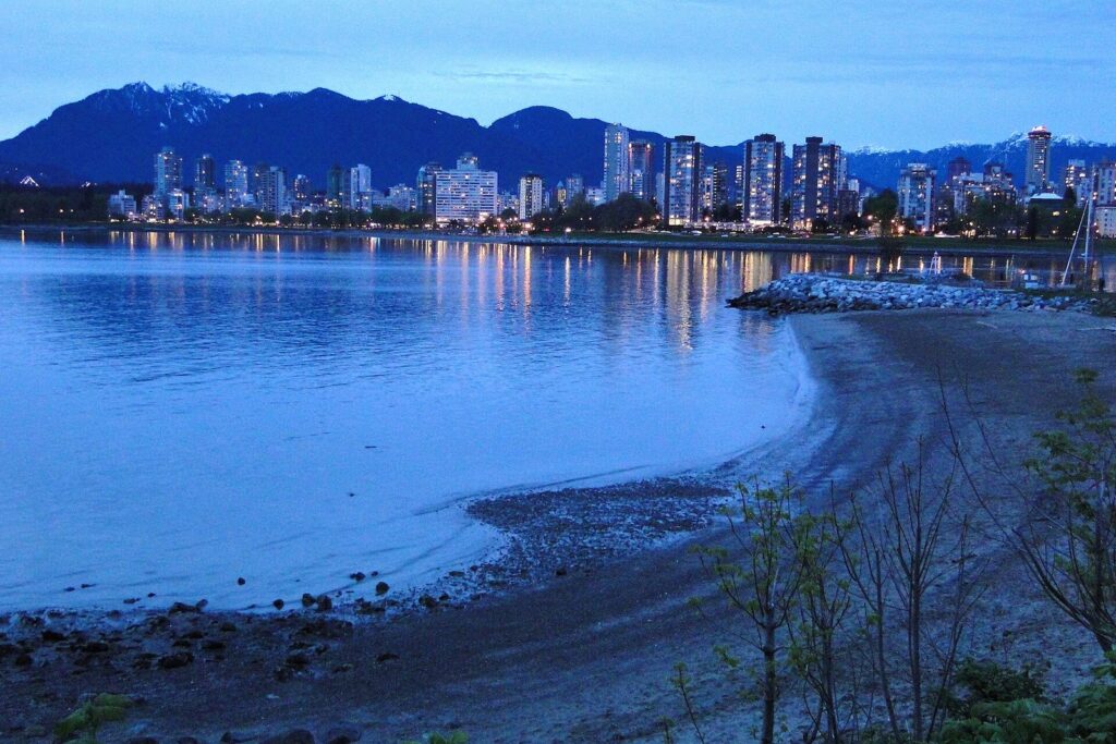 Towers of the West End and downtown at dusk seen across English Bay from Kitsilano Beach