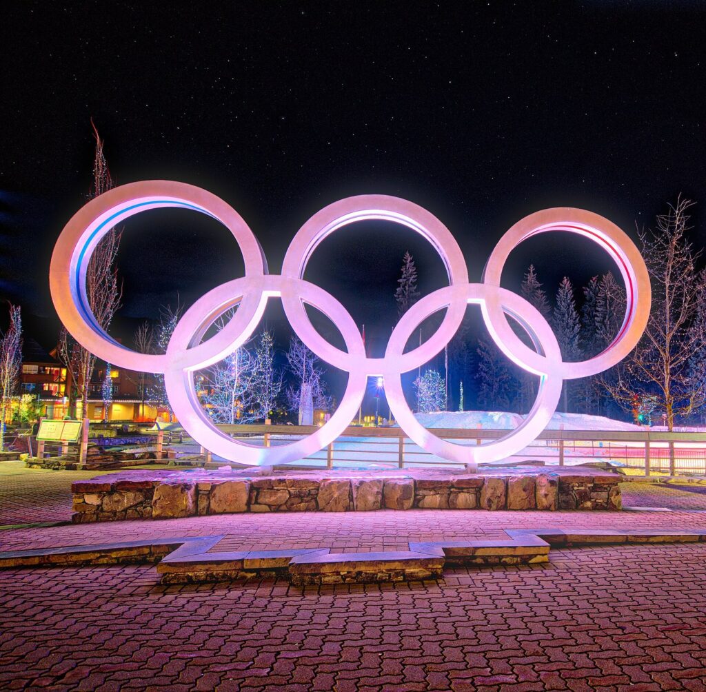 The large Olympic rings sculpture lit up at night in Whistler Olympic Plaza